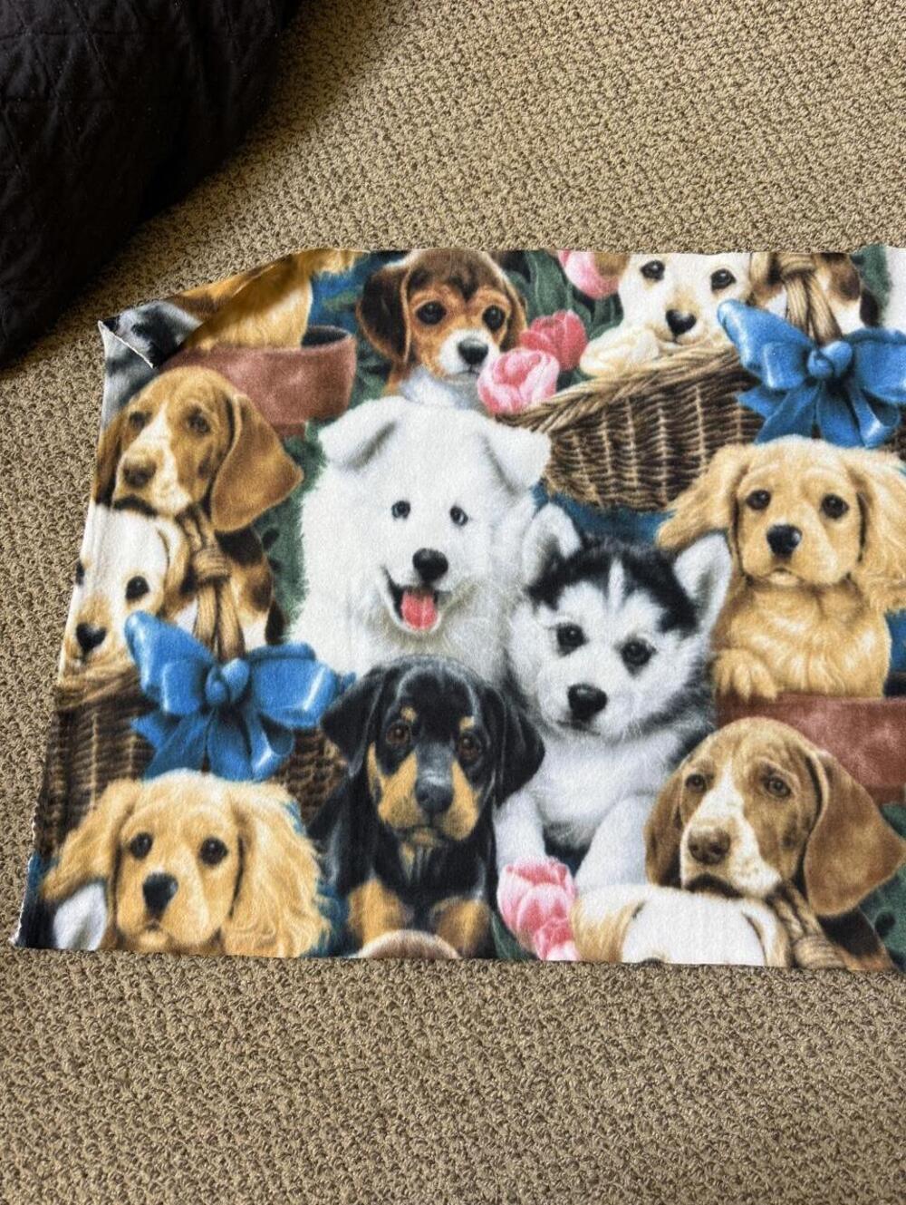Dog fabric blanket with graphic of various puppies